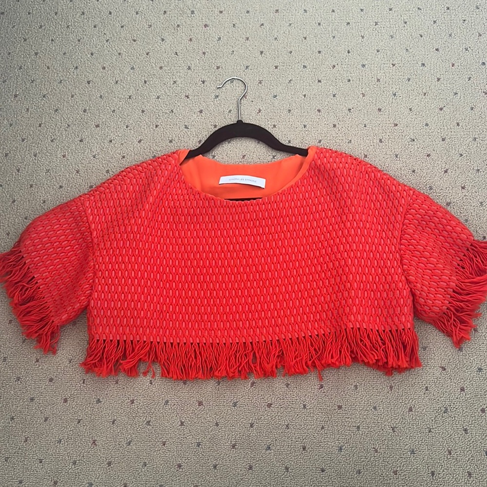 Kimora Lee Simmons orange crop top.